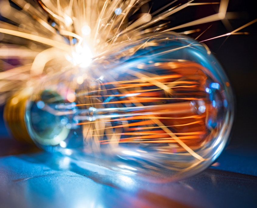 The incandescent lamp does not shine brightly and sparks fall on the metal surface in a dark room